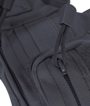 Business traveler sliding slim-profile sling pack into airport security bin, quick-access passport sleeve facing upward for inspection